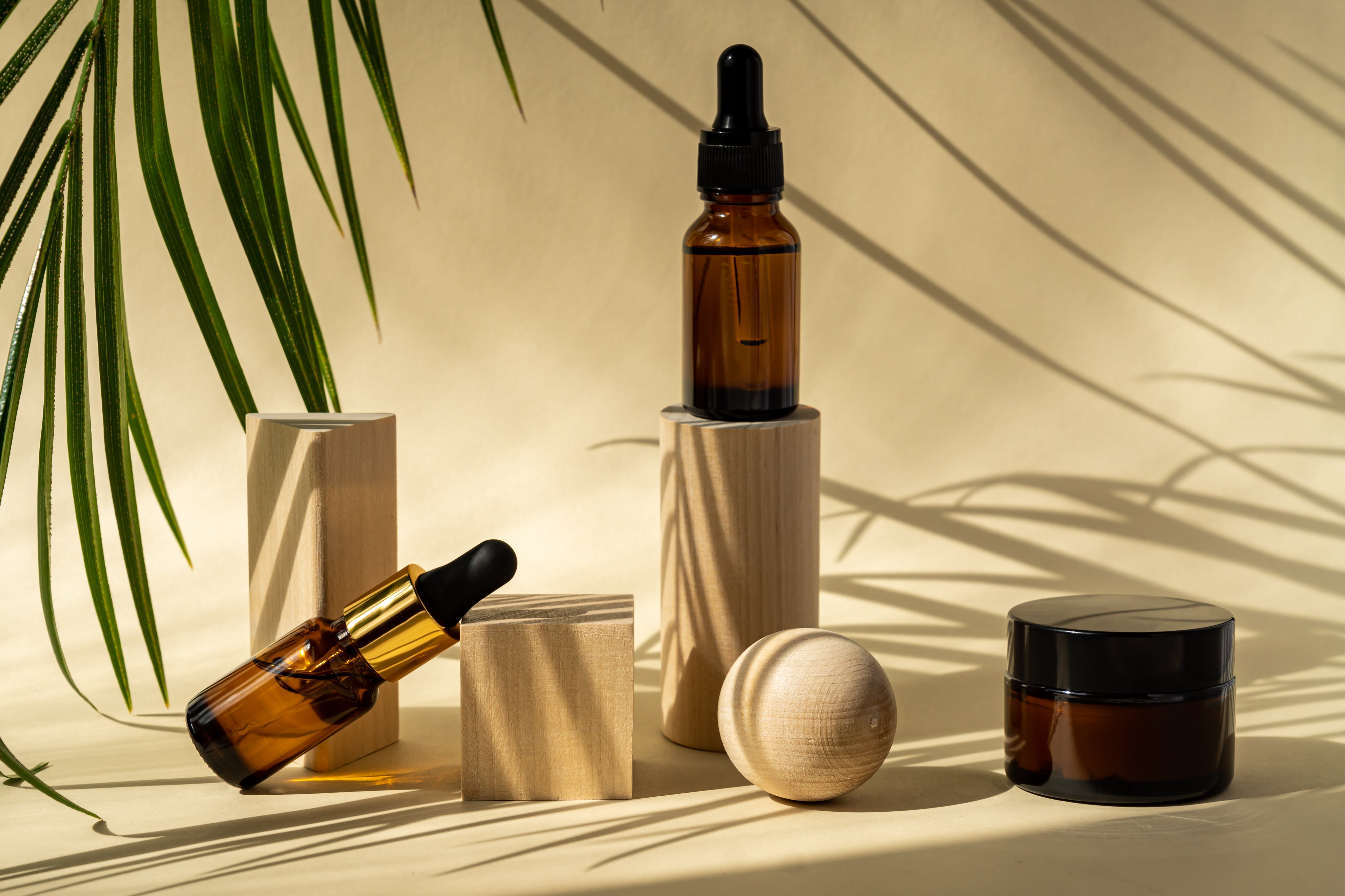 amber-cosmetic-bottles-with-pipette-wooden-geometric-pedestal-podiums-product-packaging.jpg