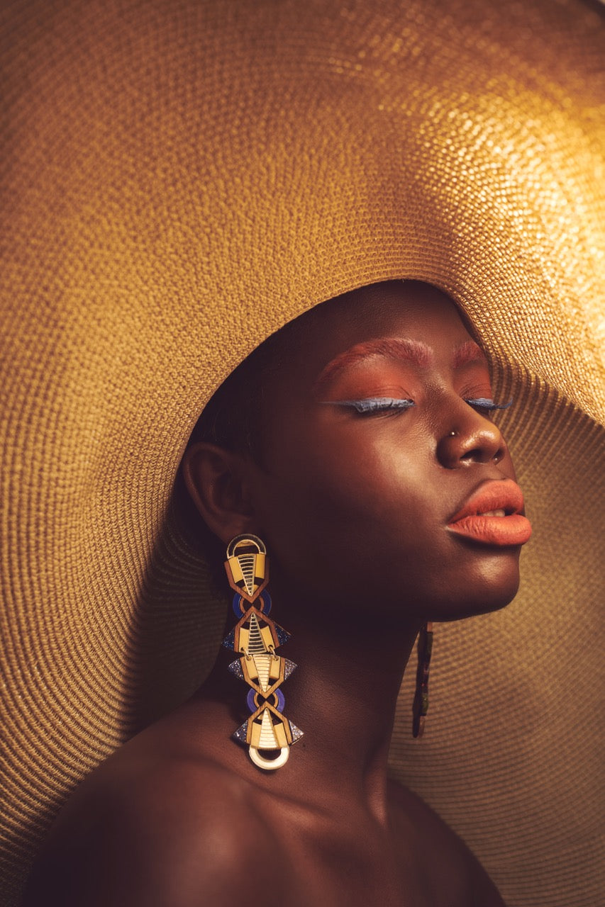 black-woman-large-sun-hat-statement-earrings-with-eyes-closed_groot_a69e5211-61b1-48dd-9609-a114583c8218.jpg